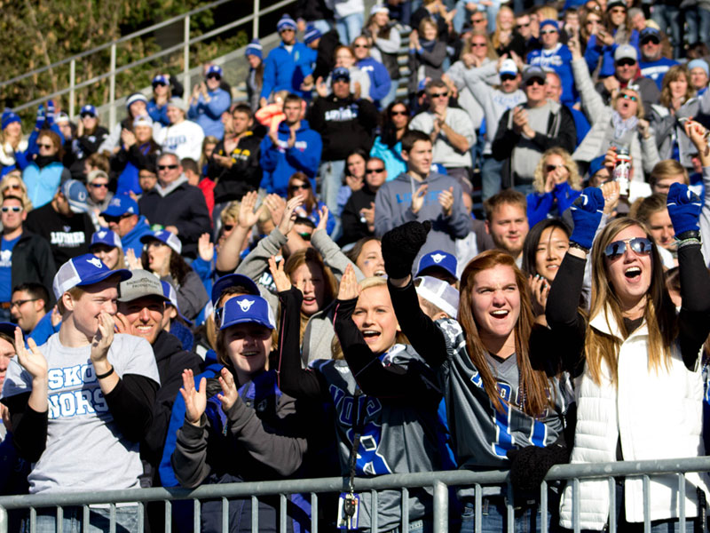 Students cheering at a Luther football game.
